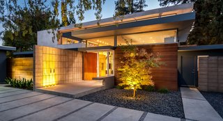 A Year of Careful Study Leads to a Thoughtful Renovation of a 1949 Eichler - Photo 2 of 10 - Jay and Melissa embraced the general configuration of the original house, which was a low, broad shape that stretches out horizontally. While the two wings on the side were remodeled and renovated, the original sections are now marked by a blue finish. The cedar and stucco elements were new additions.