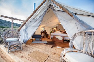 Each Signature Luxury Tent is built with wood floors and a canvas shelter. They’re equipped with electricity, a working chandelier, high-quality bed linens, and a French press coffee bar. You’ll also stay extra warm with a wood burning fire stove that’s placed in every room, as well as a tea kettle that's at your disposal.