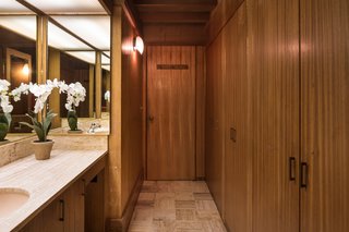 The Midcentury Home That Daniel Liebermann Built For His Parents Asks $2.8 Million - Photo 8 of 16 - The only full privacy that exists in the main house—since everything is surrounded by glass—is in a cube that Jay placed in the center of the house. It’s seven feet tall, covered with a thin sheet of fiberglass to let the light stream in from a skylight, and holds two-and-a-half bathrooms. The woodworking here is done with a mahogany finish.
