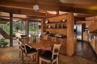 The Midcentury Home That Daniel Liebermann Built For His Parents Asks $2.8 Million - Photo 5 of 16 - Liebermann built the dining table himself, which was inspired by Frank Lloyd Wright’s furniture. Jay told us that the original corners were so sharp, that his father rounded them out to make it work better for his large family—without losing the spirit of the table. It’s made with topical hardwood and is held together with epoxy joineries. 