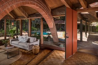 The Midcentury Home That Daniel Liebermann Built For His Parents Asks $2.8 Million - Photo 2 of 16 - The original red front door leads directly into the living room, which has oak parquet flooring and a radiant heating system throughout that still works to this day. 