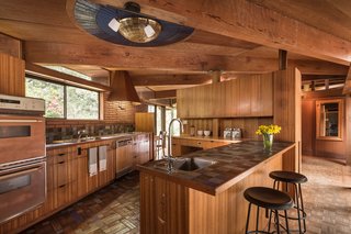 The Midcentury Home That Daniel Liebermann Built For His Parents Asks $2.8 Million - Photo 10 of 16 - In the kitchen, the mother of pearl light fixture—which was installed by the Little family in the 1970s—is surrounded by three concentric rings of dark blue tiles from Sausalito-based Heath Ceramics. Liebermann installed Heath tiles in the kitchen, baths, pool, and fountain.