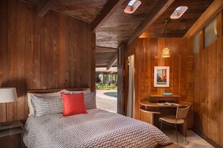 The Midcentury Home That Daniel Liebermann Built For His Parents Asks $2.8 Million - Photo 11 of 16 - Connected by the same room but 20 yards away from the main house, sits the pool or guest house, which has one bedroom and one bathroom. Liebermann built the small round desk shown here, which sits under original porthole skylights.