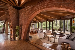The Midcentury Home That Daniel Liebermann Built For His Parents Asks $2.8 Million - Photo 3 of 16 - Liebermann and his wife Eva did the brickwork in the house—the most impressive section being the two arches that hover over the living areas and are surrounded by the home’s old-growth redwood structure. 