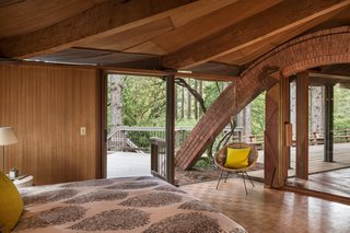 The Midcentury Home That Daniel Liebermann Built For His Parents Asks $2.8 Million - Photo 7 of 16 - One of the brick arches connects to the master bedroom, which has an accordion door installed by Jay's father that can shut off one side of the room from the rest of the living space.