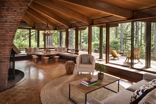 The Midcentury Home That Daniel Liebermann Built For His Parents Asks $2.8 Million - Photo 6 of 16 - In the corner of the living room sits a round table that the Little family brought from Minnesota. Jay's father made the rounded stools out of garbage cans from Cost Plus, and built the custom corner seat to create a comfortable nook. 