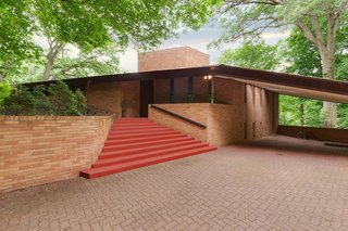 Though this home is close to downtown Minneapolis, it sits on a quiet, 3.77-acre piece of land. When you approach the brick home, it immediately becomes clear that it’s a Frank Lloyd Wright-designed home—thanks to its wing-like shape and Cherokee Red-painted steps.