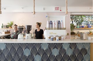 This Surf-Inspired Hotel Celebrates Waikiki’s Creative Spirit and its Midcentury Roots - Photo 9 of 13 - Olive & Oliver catches your eye on the left as soon as you enter the property. Founded by husband-and-wife team, Ali McMahon and Parker Moosman, the coffee shop is accompanied by a boutique that boasts a curated collection of fashion and home goods that are inspired by iconic surf culture.
