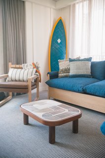 This Surf-Inspired Hotel Celebrates Waikiki’s Creative Spirit and its Midcentury Roots - Photo 10 of 13 - Studio Collective designed the 112 rooms and took inspiration from the bungalows that can be found on Oahu’s North Shore. They feature reed ceilings, batten walls, local art, and bespoke coffee tables that are topped with ceramic tiles.