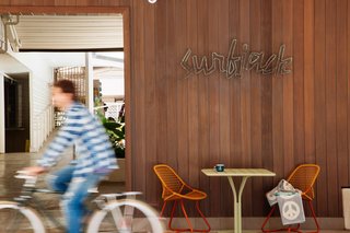 This Surf-Inspired Hotel Celebrates Waikiki’s Creative Spirit and its Midcentury Roots - Photo 1 of 13 - When you first approach the low, midcentury facade of the Surfjack, a handmade copper sign by local jewelry designer Jason Dow welcomes you into the lobby, which is open to an enticing pool and bar. 
