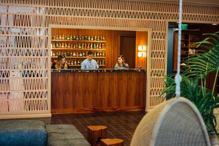 5 Striking Designs That Use Perforated Cement Breeze-Blocks in Interesting Ways - Photo 4 of 10 - Crafted from terra-cotta, a 100-foot-long wall of breeze-blocks designed by Patricia Urquiola for Mutina—called Tierras 3D—surrounds the reception window.