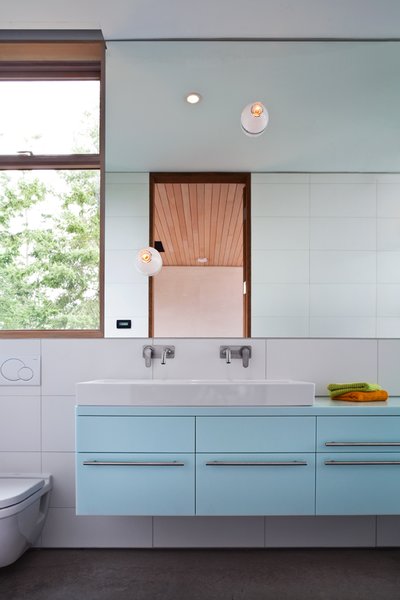The pale blue of this bathroom in the main house creates a peaceful, serene atmosphere.
#paleblue #bathroom #color #bright #beachhouse #minimal #modern #relaxing #interstice #intersticearchitects #interiorarchitecture #bathroomdesign #bradlaughton #bradlaughtonphotography Photo 20 of TreeHugger modern home