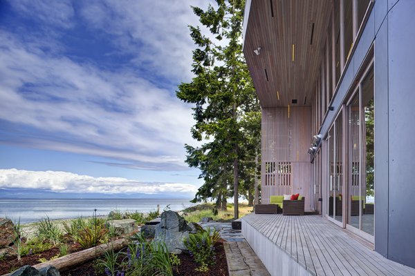 The main house is clad in the local Douglas fir with deep protective eaves, stained grey to match the sun-bleached drift wood logs that litter the coast.
#facade #residential #residentialarchitecture #coastline #beachhouse #beachhouses #view #porch #beachfront #britishcolumbia #vancouverislands #bradlaughton #bradlaughtonphotography Photo 10 of TreeHugger modern home