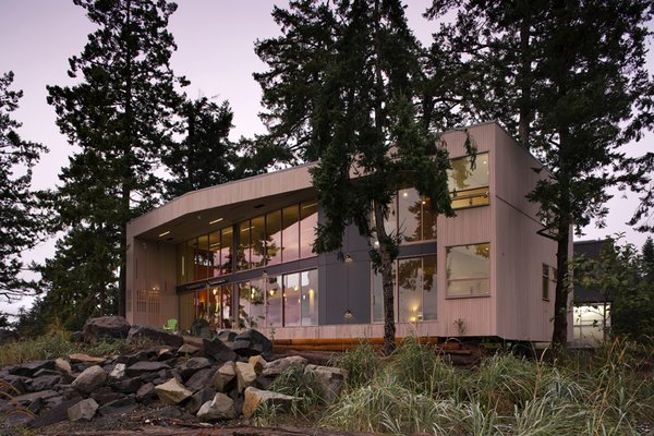 The geometric dwelling acts as two organically interconnected frames, one mineral and one of wood which float above a virtually undisturbed site between one of the world’s richest marine tidal ecosystems to the northeast and a wetland preserve to the southwest. The extremely limited lot was dominated by a traversing grove of 350-year-old Douglas fir trees into which the home was surgically inserted in order to share their shelter which provides essential habitat for bald eagles and a host of other wildlife.
#wildlife #architecture #facade #trees #beachhouses #beachhouse #interstice #intersticearchitects #bradlaughton #bradlaughtonphotography #britishcolumbia #vancouverisland #residential #residentialarchitecture Photo 2 of TreeHugger modern home