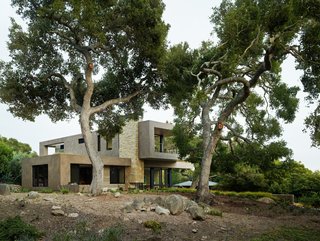 From the Architect: "The 3,500-square-foot Lilac Drive Residence is located on a lush lot in the foothills of Montecito. Designed to nestle into the landscape, the home is composed of a variety of natural materials including local Santa Barbara sandstone, reclaimed wood, and smooth-troweled, dark-finished cement plaster. Oak trees are protected in Montecito, so the shape of the house was determined both by the trees and the pathway of a protected creek that runs through the property. Intersecting roof planes and deep roof overhangs define the design of the residence. Green roofs accentuate the second story, floating above the entrance and flanking the master bedroom and its private deck in the rear. Walls of windows and sliding glass doors line the rear of the home on both levels, looking out over the grounds, outdoor living area, and swimming pool." 