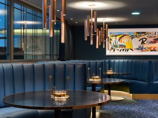 Varied seating options in the hotel's Jazz Club Etoile include leather banquettes; a new row of windows lines an interior wall to evoke an urban feel.
