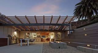 A Mid-Century Modern Makeover in Los Angeles - Photo 4 of 5 - "The rear yard, given the property's limited size, presented more of a conundrum," says Southerland. "We came up with the idea of using the roof of the garage as a roof deck to add useable area to the rear." Taking advantage of the gently sloped site, he built a series of terraced bleacher-style seating above and around the detached garage, doubling its roof as an additional terrace, and effectively bridging the backyard space into one multi-level whole.