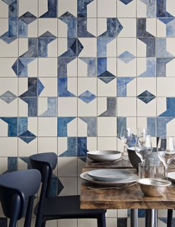 A Parisian Seafood Restaurant, Swimming in Shades of Blue - Photo 2 of 5 - A closer look at the hand-painted, ceramic tile fresco on the ground level of Belle Maison. Bonaventure also specified ceramic dishes and tableware from Broste Copenhagen; the Nemea chairs are from Pedrali.