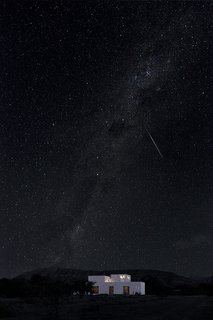 A Minimalist Retreat at the Edge of South Africa's Karoo Desert - Photo 6 of 6 - A view of the home by night, beneath the clear and starry desert sky.