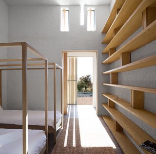 A Minimalist Retreat at the Edge of South Africa's Karoo Desert - Photo 3 of 6 - Openstudio worked with local builders, using a palette of regional materials: patterned brick, white ceramic tiles, and roughcast lime-washed plaster. Custom built-ins accentuate the linear light and shadow cast by the elongated windows.