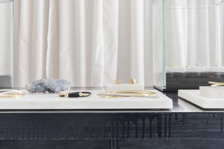 This Brooklyn Boutique Is an Oasis of Calm in the Busy City - Photo 5 of 6 - "The details of the table design are a counterpoint to the fine jewelry and accentuate the beauty of each piece," Roberts says of the hand-dyed Scout + Gather creations, which are dyed a rich blue-black and feature rough plywood edges with intentionally dripping paint.