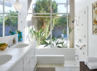 This Palm Springs Hotel is Filled with Vintage Midcentury Modern Finds - Photo 2 of 5 - The Jungle bathroom at the Monkey Tree hotel in Palm Springs. Accessories and art like the roadrunner needlepoint wall hanging were largely "made by regular people and found in vintage stores," Kathy says.