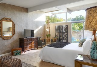 This Palm Springs Hotel is Filled with Vintage Midcentury Modern Finds - Photo 3 of 5 - The new hotel's Jungle bedroom, stocked with finds from places like The Estate Sale Company, where it's not unusual to find treasures from the Parker Palm Springs, located just across the street. Other scores came from the now-shuttered Lot 58 auction house. "It was great fun to bid and win. I can become very cut-throat if I wanted something, giving the evil eye to those trying to outbid me," Kathy says. 
