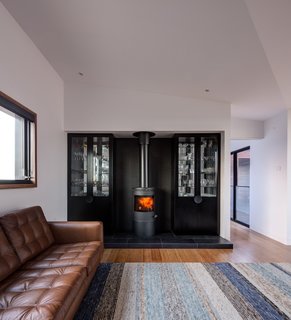 A Morsø space heater warms the living room, which features a rug from Halcyon Lake.