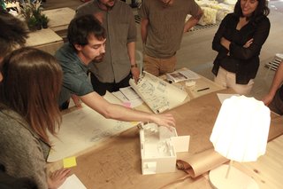 Reinventing the Family Home for the Boomerang Generation - Photo 3 of 10 - The ENORME Studio team works with a model to develop the Home Back Home #03 prototype project.