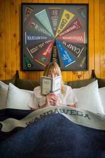 This Wisconsin Hotel Suite Conjures the Best of Summer Camp—Hold the Bug Spray - Photo 7 of 9 - The walls of the suite's main room are lined with amber-shellacked pine, recalling Wandawega's cabins—and retro family basements. 