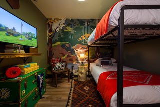 This Wisconsin Hotel Suite Conjures the Best of Summer Camp—Hold the Bug Spray - Photo 1 of 9 - The media room features custom-designed bunks with Camp Wandawega for Land of Nod bedding. The mural recalls paint-by-number landscapes.