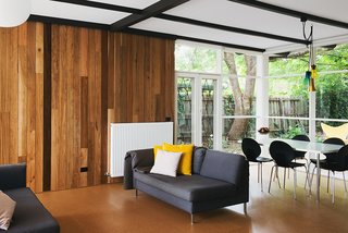 An Australian Renovation Gives New Life to Midcentury Style - Photo 3 of 14 - Timber clad walls meet cork flooring in the open living room at the center of the home.