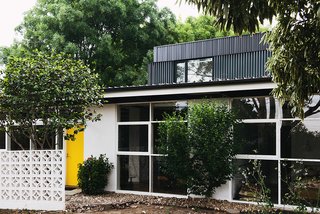 An Australian Renovation Gives New Life to Midcentury Style - Photo 1 of 14 - The yellow hue on the front door is a detail that Nest Architects picked up from the original design. So is the block wall. 