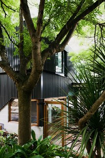 An Australian Renovation Gives New Life to Midcentury Style - Photo 2 of 14 - A new volume, clad in black aluminum, houses two bedrooms.