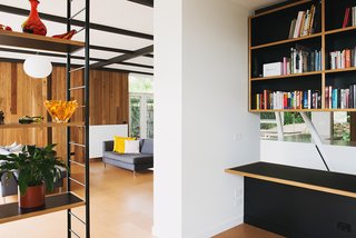An Australian Renovation Gives New Life to Midcentury Style - Photo 7 of 14 - The built-in cabinetry reverses the home's usual organizational motif of a black grid against a timber frame. 