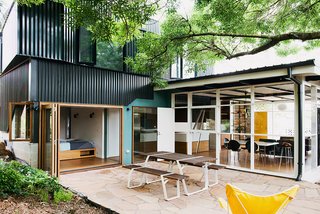 An Australian Renovation Gives New Life to Midcentury Style - Photo 11 of 14 - The result is a multipurpose living area that opens up to an exterior courtyard anchored by a Ross Gardam Flint table.