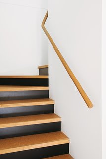 An Australian Renovation Gives New Life to Midcentury Style - Photo 9 of 14 - Even the stairs reflect the materials at the heart of the project with their blend of cork, timber, and black against a white backdrop.