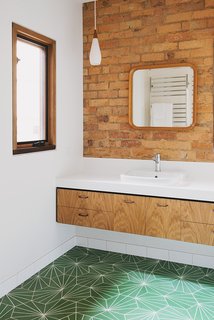 An Australian Renovation Gives New Life to Midcentury Style - Photo 13 of 14 - The residents chose the bathroom's Pikralida Green tiles from Tilenova in Sydney. "They loved the geometry of the tiles and the patterns, which somewhat harked back to a midcentury style," architect Emilio Fuscaldo says. 