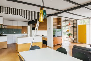 An Australian Renovation Gives New Life to Midcentury Style - Photo 12 of 14 - The black framework separating the kitchen and dining area was meant to echo the exterior cladding. Additional black details give the space a grounding geometry. 