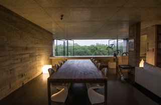 An Architect's Home and Studio Rises Above Rajagiriya - Photo 2 of 6 - Expanses of low-e glass open to views of the nearby greenery. Designed by the architect, these 15-foot-tall panes virtually disappear when moved to the side.