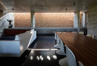 An Architect's Home and Studio Rises Above Rajagiriya - Photo 3 of 6 - The primary living area opens to the main volume below it. The perforated brick walls aid with heat management.
