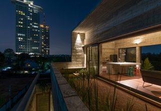 An Architect's Home and Studio Rises Above Rajagiriya - Photo 4 of 6 - A roof deck offers views of both the city and the surrounding marsh. The roof's biological ponds regulate stormwater, while its edible herb gardens and paddy fields help to keep the interior of the home cool despite the tropical heat. 