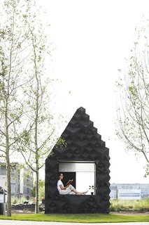Stay in This 3D-Printed Tiny House - Photo 11 of 19 - The Urban Cabin includes a sofa that doubles as a twin bed, a small porch and amble glazing.