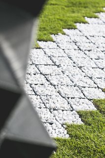 Stay in This 3D-Printed Tiny House - Photo 2 of 19 - A pebble path echoes the patterns of the printed cells and the concrete that fills them.
