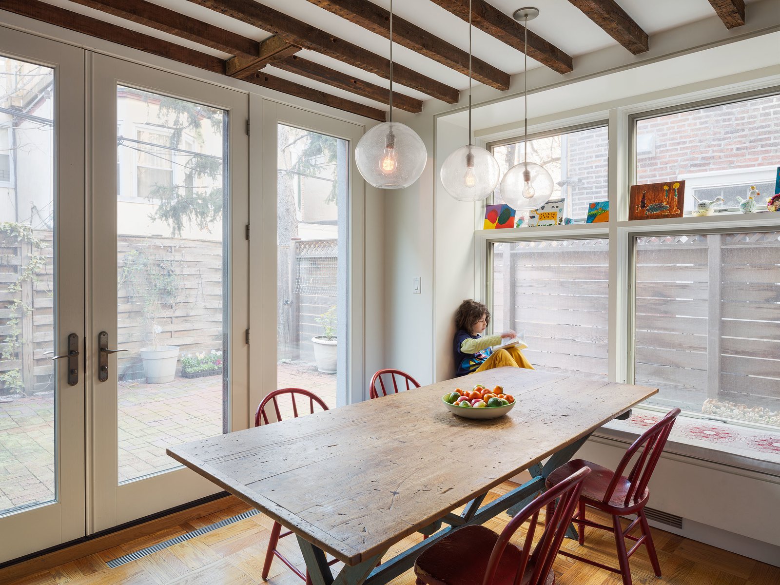 Philadelphia Row House Renovation - Photo 5 of 8 - Dark beams contrast the glazing that fills the dining area with light, continuing the home's historic/modern mix.