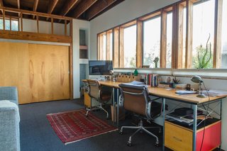 Peek Inside the Frank Gehry Rental of an Emerging L.A. Furniture Designer - Photo 7 of 11 - Vintage Soft Pad chairs by Charles and Ray Eames for Herman Miller (an eBay find) and matching new Eames desk and storage units, also from Herman Miller, furnish a workspace on the mezzanine level. "When we're both at home we speak to each other all the time," William says of the openness of the house. 