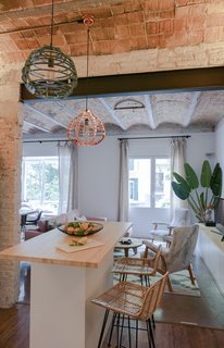 The open kitchen is the centerpiece of the renovated apartment. Bloomint designed the island. 