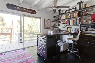 Graphic Design Inspired This Handcrafted Canyon Hideaway - Photo 8 of 10 - The office is filled with personal projects. Chad built the desk using Husky utility cabinets. A photograph from a photoshoot he did with Lil Wayne is printed on the work surface.