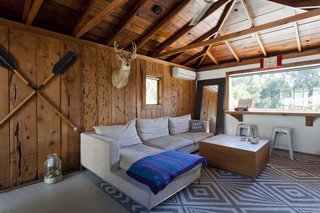 Graphic Design Inspired This Handcrafted Canyon Hideaway - Photo 10 of 10 - Though brightening the house was a top priority, the couple kept the original cedar cladding and raw redwood ceiling in the guest house as a nod to the home's original style.