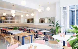 Most of the furniture is custom by ASH NYC. Surrounding the white oak and Carrara marble tables are chair-bench hybrids that ASH calls "Chenches". 